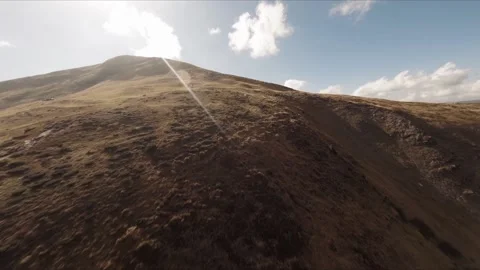 FPV Drone footage: Smooth Stabilized Fly along Mountain Rocky Hill around Stock Footage 162808840