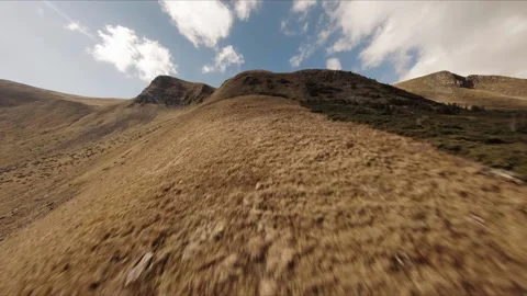 FPV Drone footage: Smooth Stabilized Fly along Mountain Rocky Hill around Stock Footage 162808893