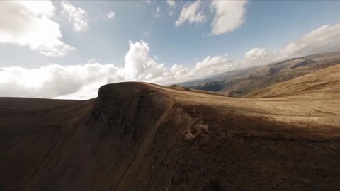 FPV Drone footage: Smooth Stabilized Fly along Mountain Rocky Hill around Stock Footage 162808900
