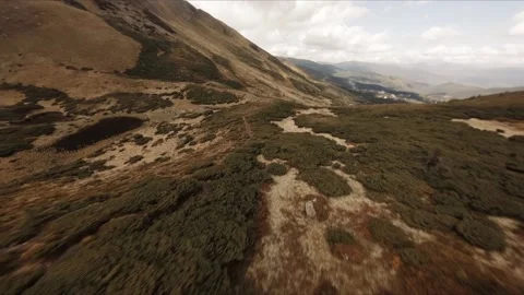 FPV Drone footage: Smooth Stabilized Fly along Mountain Rocky Hill around Stock Footage 162829409