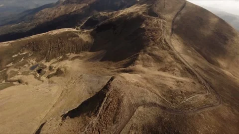 FPV Drone footage: Smooth Stabilized Fly along Mountain Rocky Hill around Stock Footage 162829529