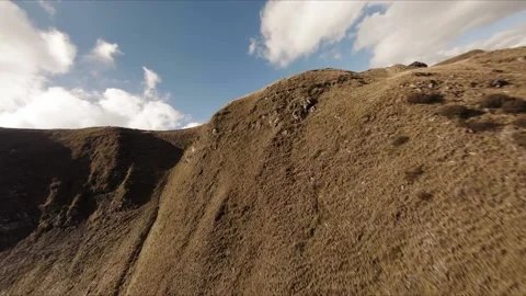 FPV Drone footage: Smooth Stabilized Fly along Mountain Rocky Hill around Stock Footage 162829599