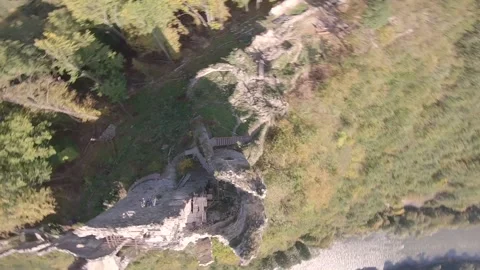 FPV drone freestyling around an ancient castle in high green mountains Stock Footage 169280652
