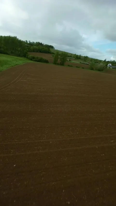 FPV drone glide above patchwork farmland in Brittany, France Stock Footage 327438825