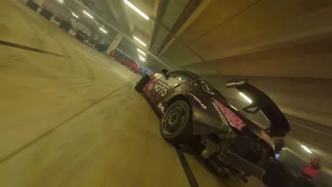 FPV Drone Low-Angle Drift: Grey-Pink Nissan 350 in Battle with Red BMW Stock Footage 327029695