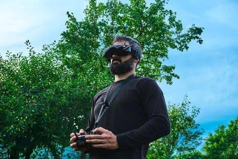 FPV drone man pilot controlling flying copter outdoor Stock Photos