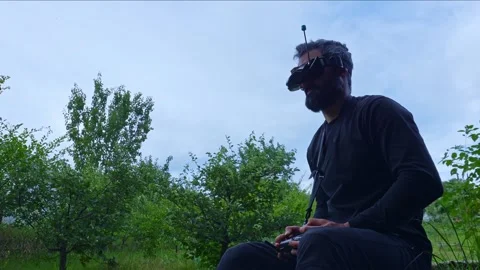 FPV drone man pilot takes of headset googles after work flight outdoor blue sky Stock-Footage 280365275