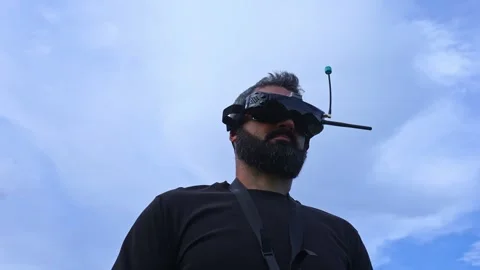 FPV drone man pilot waist up portrait outdoor on blue sky background 4K video Stock Footage 280365250