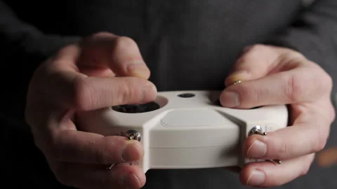 The FPV drone operator controls the flight. Hands with remote control close-up Stock Footage 264041582