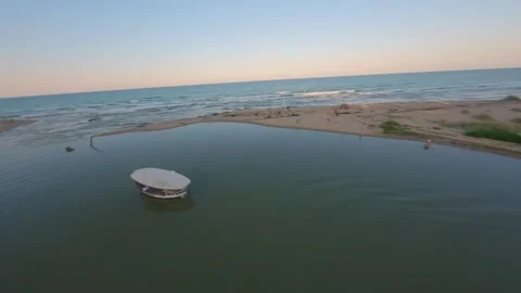 FPV drone orbit around boat at Kamchia River mouth on the Black Sea, Bulgaria. Stock Footage 342544700