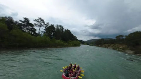 FPV Drone Orbit Around Rafting Boat on Scenic River Stock Footage 309037453