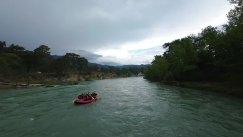 FPV Drone Orbit Around Rafting Boat on Forest River Stock Footage 309037500