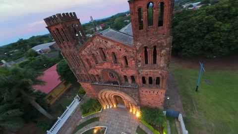 FPV drone orbit showcasing facade, brick tower bells and rooftop of Nuestra 스톡 동영상 334250769