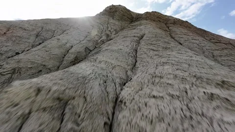 FPV drone pullback descending over Aktau Mountains in Altyn Emel National Park. Video stock 335074642