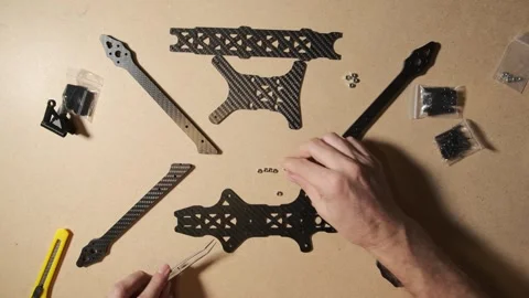 FPV drone quadcopter frame assembly at home. Modern weapon crafted by an en.. Stock Footage 330969801