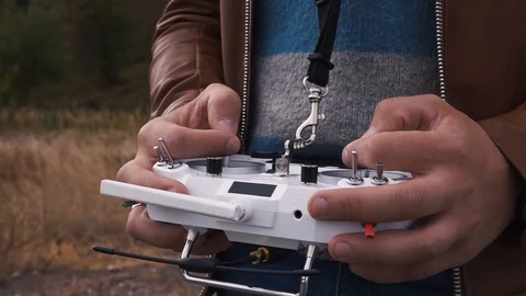 FPV drone racer holding remote control close up 動画素材 116959967