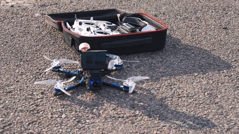 FPV drone racing, controller and glasses in box lie on asphalt 스톡 동영상 116960861