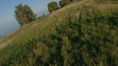 FPV Drone racing view. Dynamic flight over dirt road and fields Stock Footage 116961092