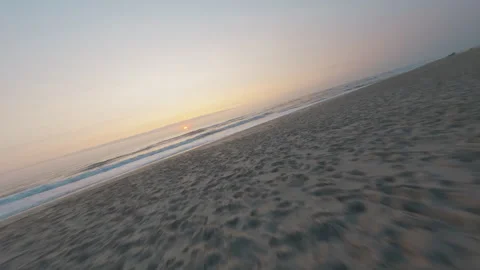 FPV Drone From Sand to Breaking Waves at Sunset, Low Beach Flight, Portugal Stock Footage 327414507