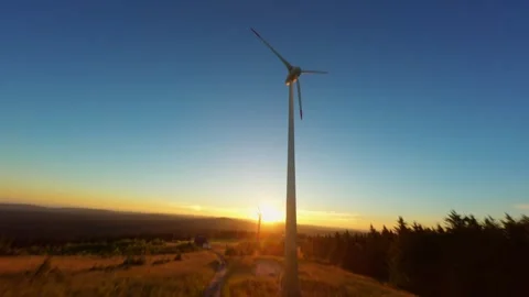 FPV Drone Shot Around Wind Turbine at Sunset Over Field Stock Footage 305804309