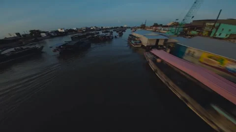 FPV drone shot of Cai Rang floating Market sunset in Can Tho in Vietnam Stock Footage 242914407
