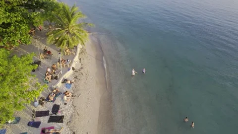 Fpv drone shot captures a sunset over a crowded seaside zen beach location in Stock Footage 320655792