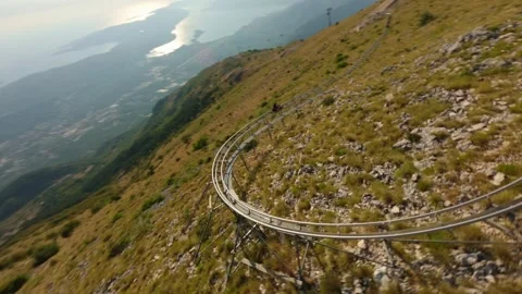 FPV drone shot chasing a person on the Alpine Coaster 스톡 동영상 332115286