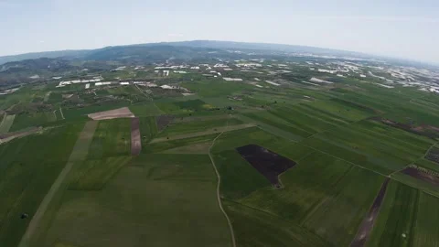 FPV drone shot over the flat patchwork farmland of the Sicilian interior, with Video stock 334267847