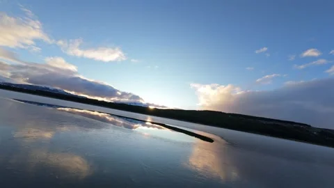 FPV Drone Skimming Over Reflective Laguna La Zeta at Sunset Stock Footage 337934307