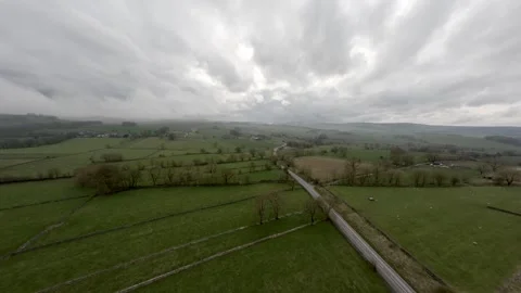 FPV drone swoops over road in the Peak District, Colour Corrected Stock Footage 271144092