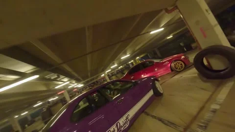 FPV Drone Tandem Drift of Red BMW and Purple BMW Compact Underground Stock Footage 327027937