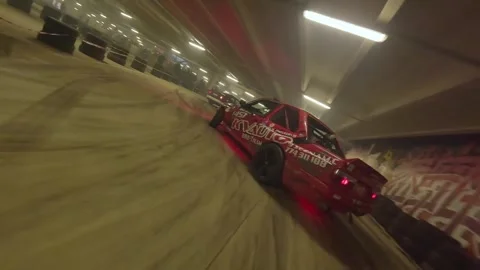 FPV Drone Underground Drift: Red BMW with Underglow vs Purple BMW Stock Footage 327030431