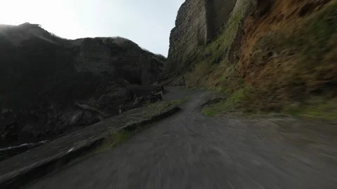 FPV drone video of flying close through a bay, cliffs, ocean, adventure Stock Footage 308413719