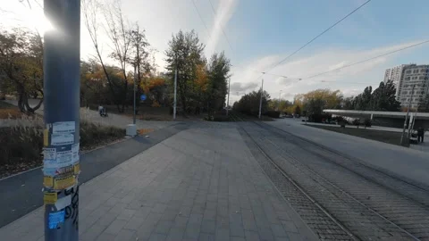 FPV drone view flies next to the tram rails on the bike path. Stock Footage 220000007