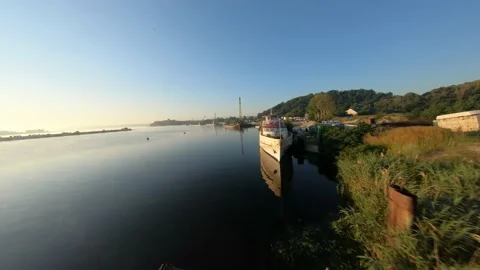 FPV drone view of flying over water at dawn past an abandoned ship Vídeos de archivo 169505343