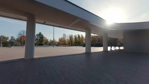 FPV drone view of Guys are skating on the square next to the modern building Stock Footage 216935054