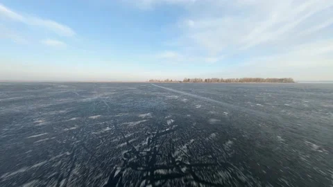 FPV drone view of low and fast flight over the frozen river at sunset Vídeos de archivo 147089411