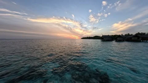 FPV Drone View of Maldives Resort and Crystal Clear Coral Reef at Sunrise Stock Footage 342025649