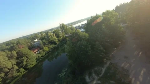 FPV drone view quickly flies near an unfinished apartment building and over the 動画素材 169504925