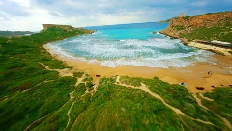FPV drone view sea waves on Ghajn Tuffieha beach, popular Malta beach Stock Footage 314669195