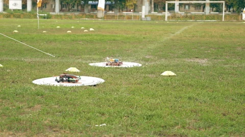FPV drones taking off and flying away over grass Stock Footage 67956808