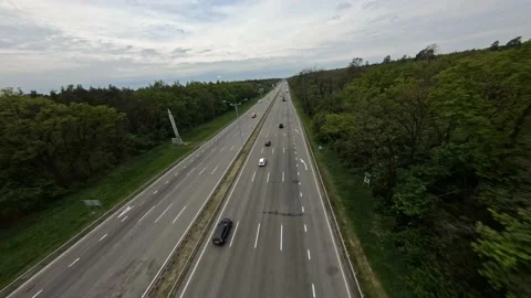 FPV flight along a nearly empty highway passing through the forest Stock-Footage 168403327