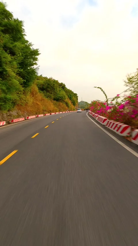 FPV Flight Behind A Car Driving On A Scenic Cliff Road On Cat Ba Island Vietnam Stock Footage 266767157