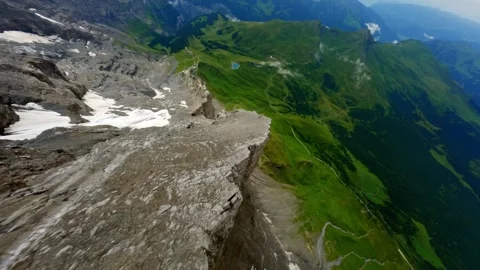 FPV Flight diving down west flank of the EIGER Switzerland Grindelwald Stock Footage 293741172