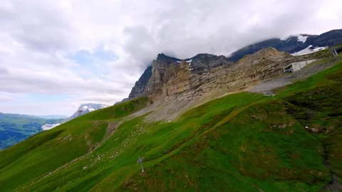 FPV Flight diving down west flank of the EIGER Switzerland Grindelwald Stock Footage 293741689