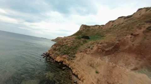FPV flight over a coastal cliff at cloudy day Stock-Footage 168883403