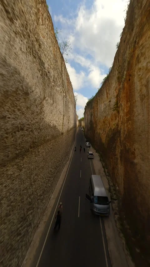 FPV flight over the road in cliffs near Batu Barak beach in Bali, Indonesia Stock Footage 283723188