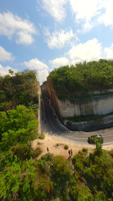 FPV flight over the road in cliffs near Batu Barak beach in Bali, Indonesia Stock Footage 306518128
