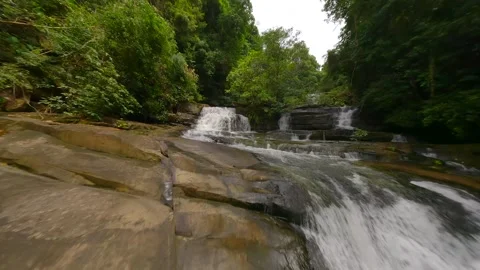 FPV flight over tropical river and waterfalls among the lush jungle in Thailand Stock Footage 256202775