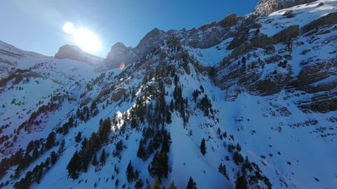 FPV flight past a sunlit snowy mountain in the Pyrenees Stock Footage 346003708